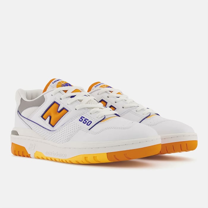 View of white, orange, purple New Balance 550 shoes.